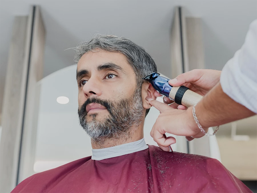 Professional barber performing a straight edge razor shave in Meyerland with expertise.