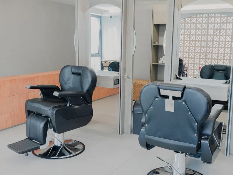 Spacious Barber Shop in Houston featuring stylish black chairs and a clean workspace