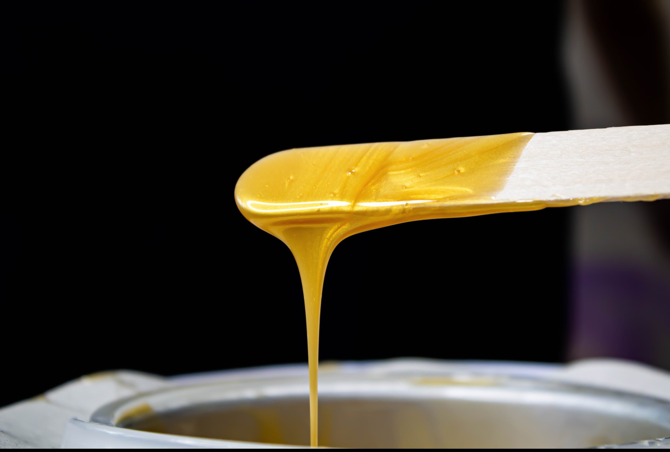 Relaxing Straight Shave Houston: Fresh, melted sugaring paste applied for smooth, professional hair removal.