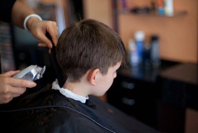 Kids haircut Houston featuring clipper trim at a professional salon, highlighting clean technique and grooming tools.