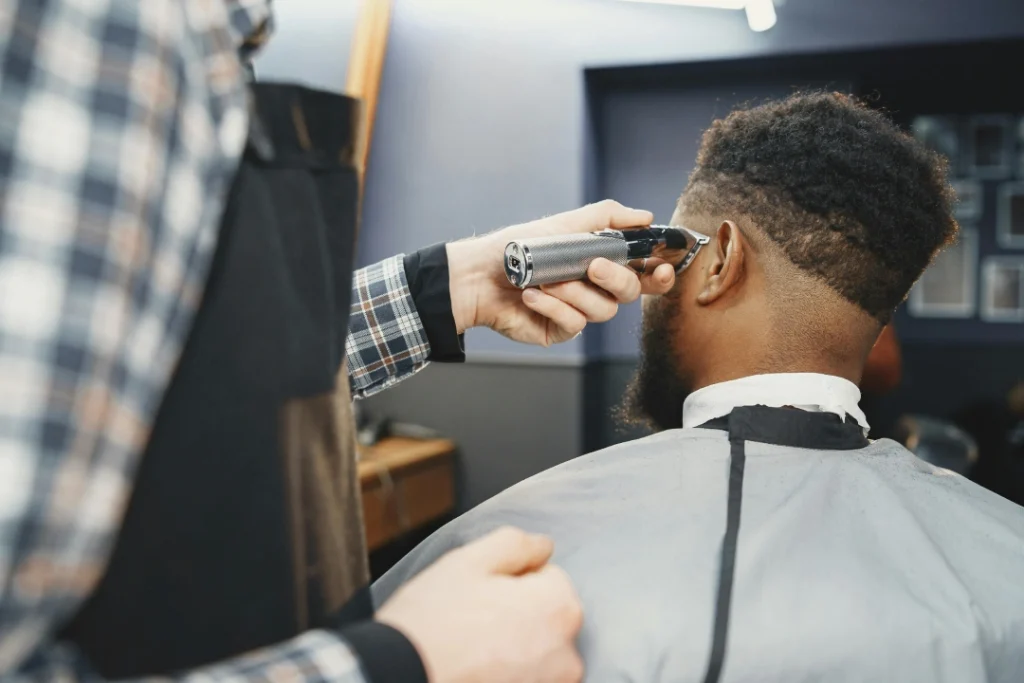 A straight razor is used for a precise fade and neck line up to complete a premium Mens haircut.