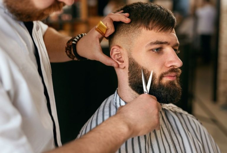 Professional beard trim by skilled barbers in Houston, showcasing precision grooming in a modern barbershop setting.