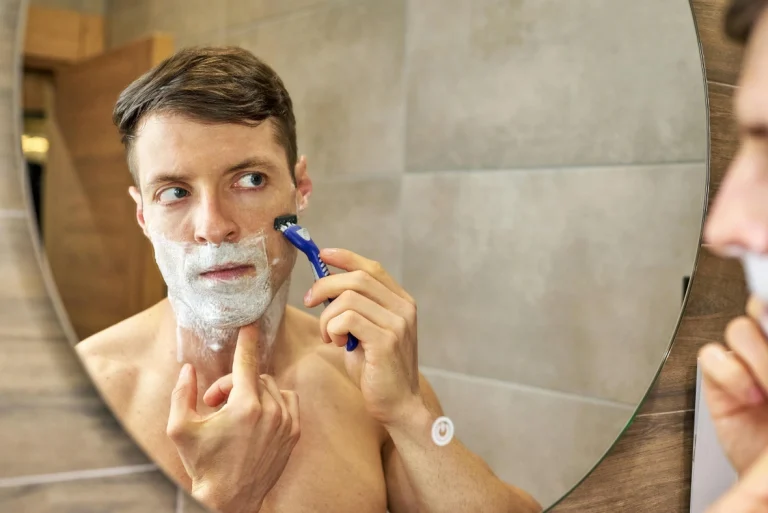 Detail of a man enjoying a traditional foam lather and meticulous Mens Shave Houston service.